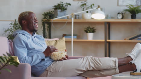 Black-Man-Laughing-and-Watching-Movie-at-Home